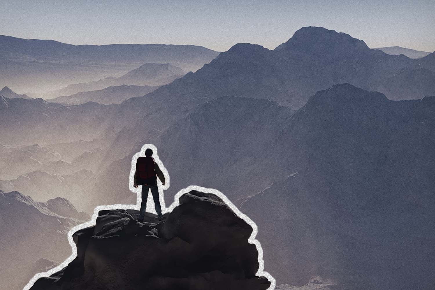 Person stands on top of mountain