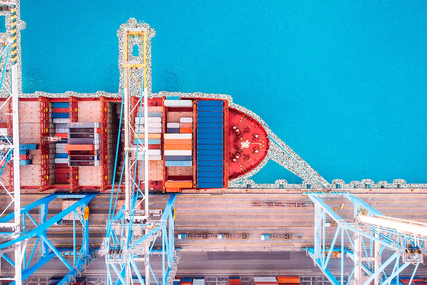 Boat in a port with shipping containers