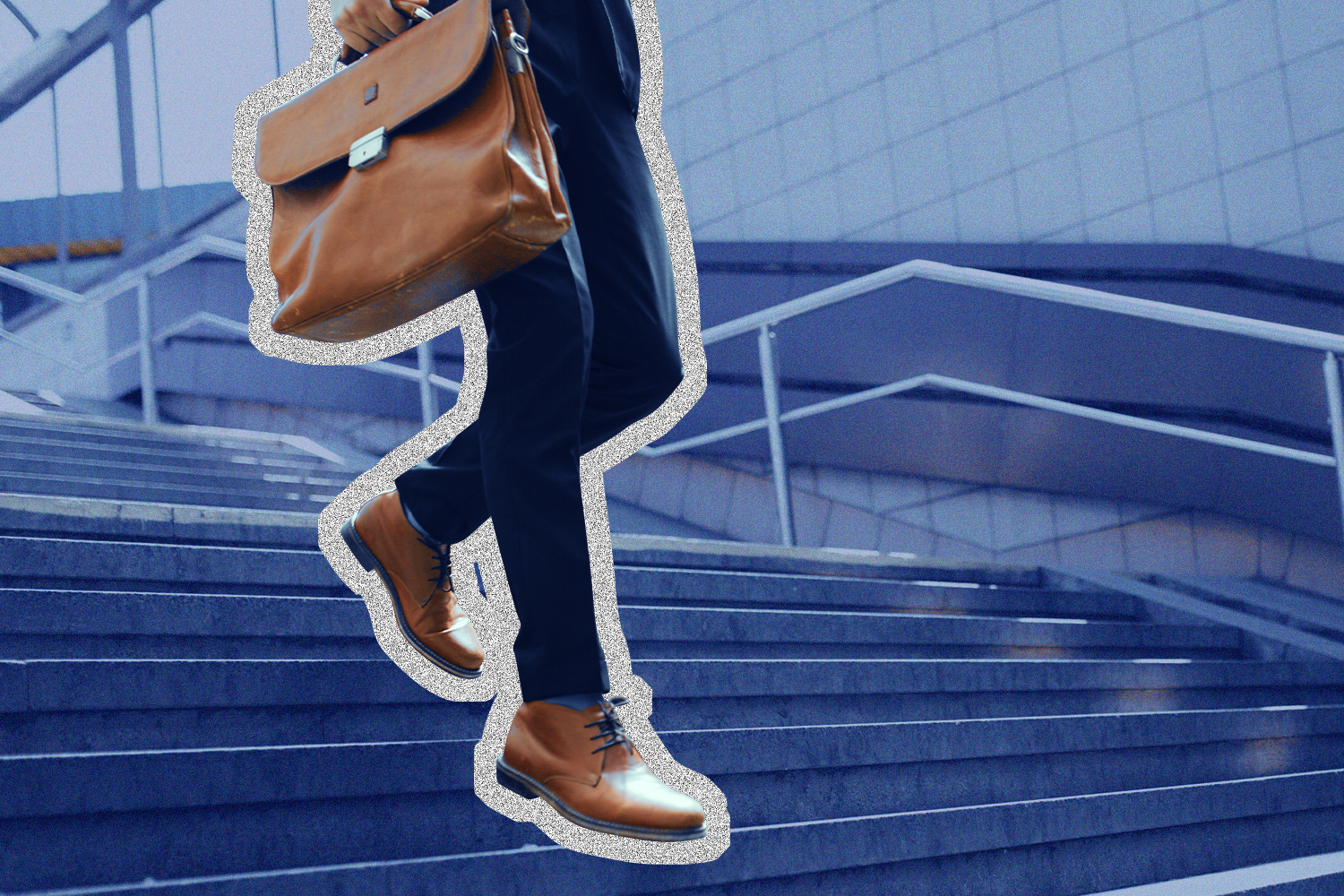 Business man in a dark blue suit walking down a flight of stairs