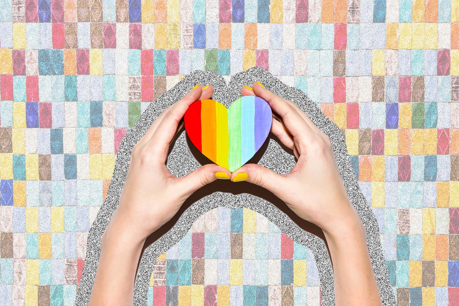 Image of hands holding a rainbow heart