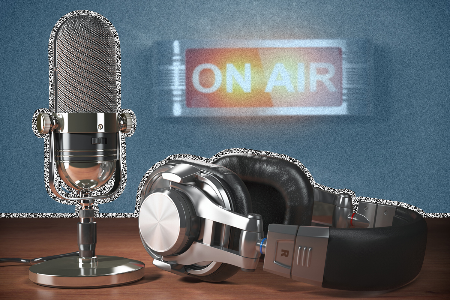 Image of headphones and microphone on table in front of an "on air" sign