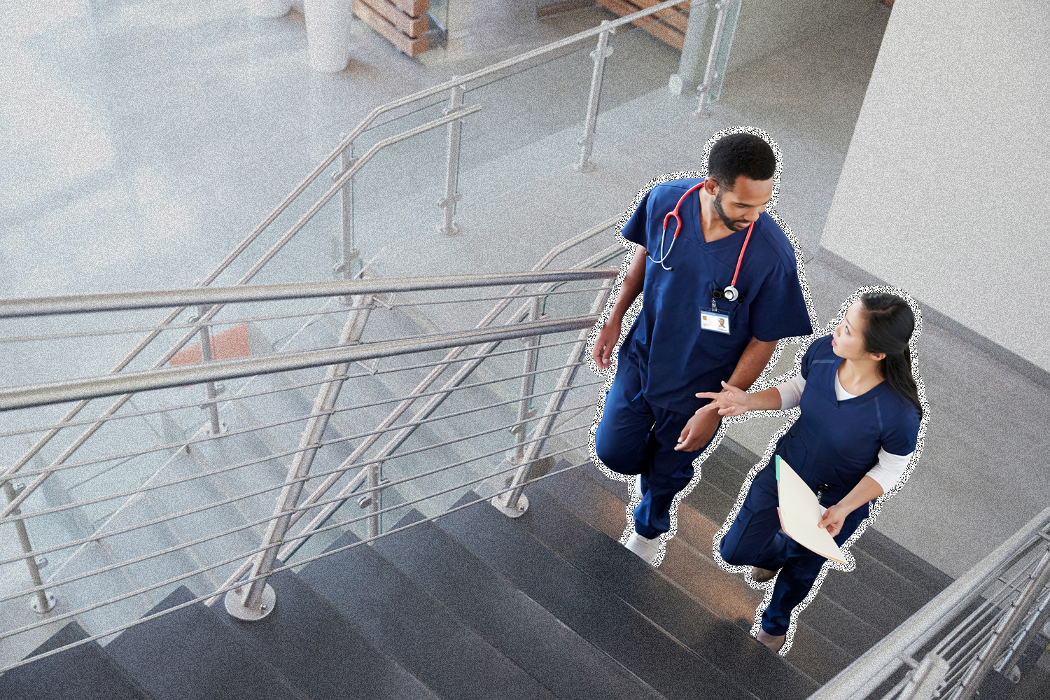 Two healthcare professionals walk up the stairs