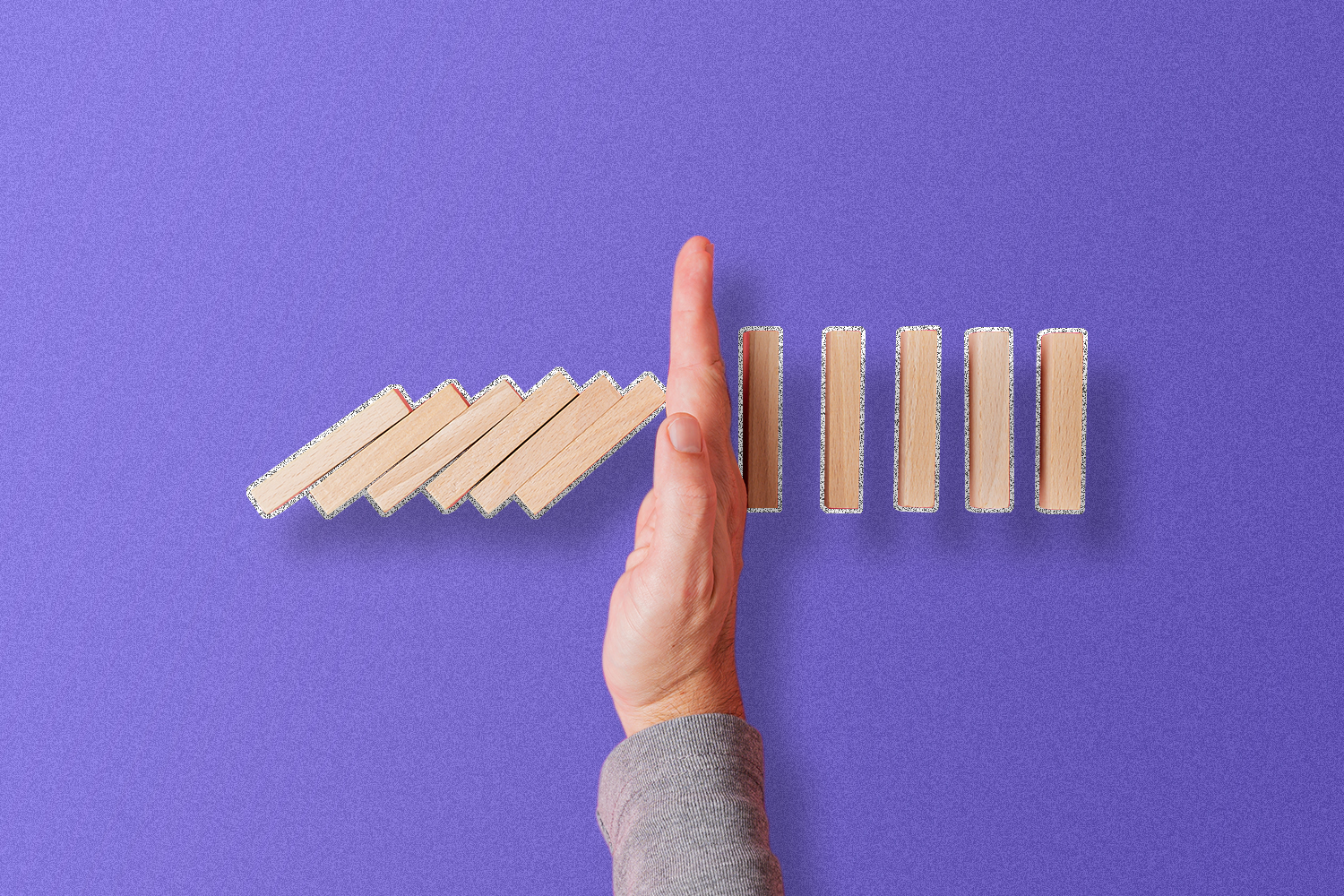 A line of falling blocks and a hand to stop them from hitting the other blocks in the line.