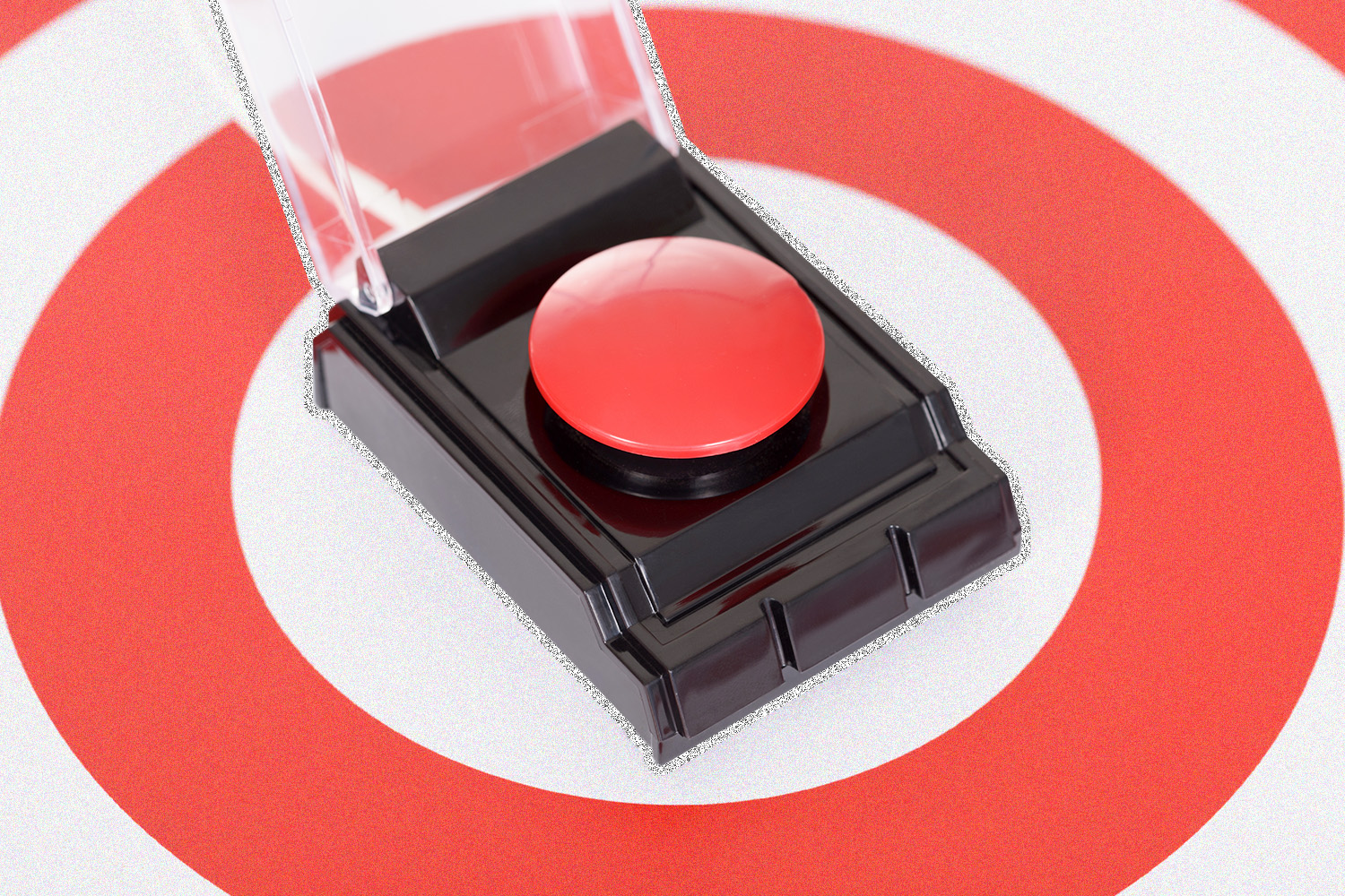 A red button sitting on a red and white target