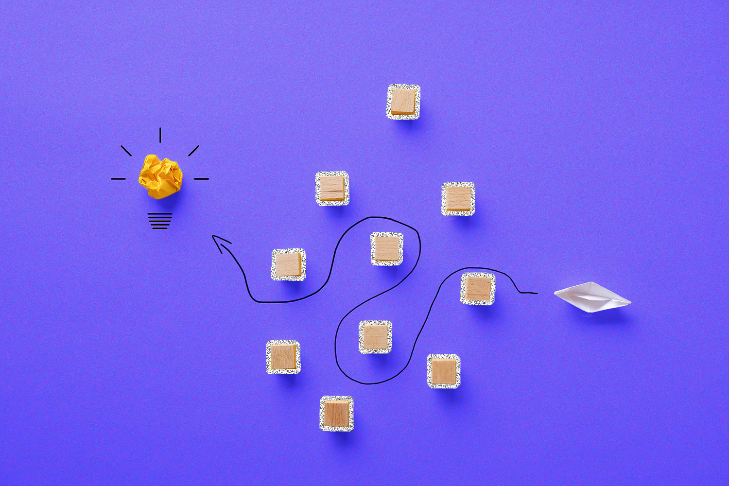A white paper boat navigating past square blocks to reach a yellow paper lightbulb on a purple background